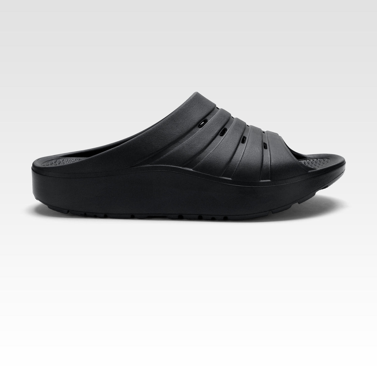 Side profile of the Oka Recovery Slide with its broad strap and cushioned sole